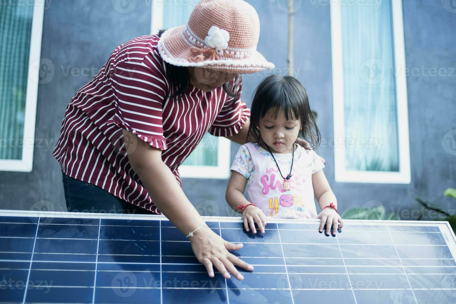 a-young-happy-family-is-standing-near-solar-panels